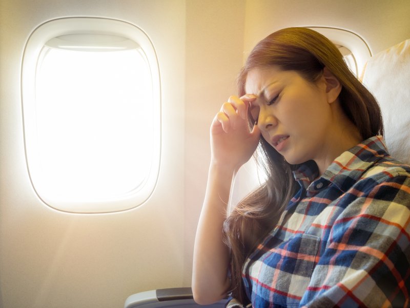 Reisekrankheit Frau Flugzeug